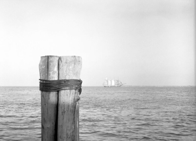 A 5-masted schooner on Currituck Sound ca. 1937-39. That was the very end of the Age of Sail in shipping, when only a few large carriers of grain, coal, fertilizer and other bulk goods still came into North Carolina waters. Photo by Charles A. Farrell. Courtesy, State Archives of North Carolina